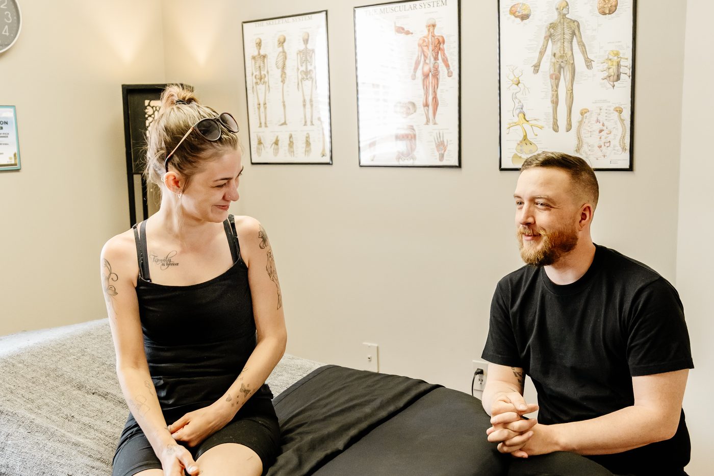 Mathieu Boudreau, RMT, speaking with a client before a massage appointment in his Moncton clinic.