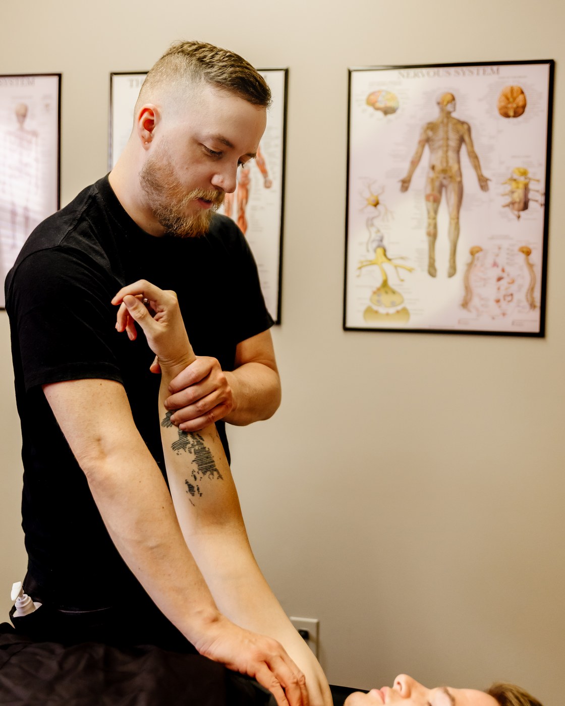 Mathieu guides a client's raised arm while applying shoulder contact during RAPID NeuroFascial Reset.