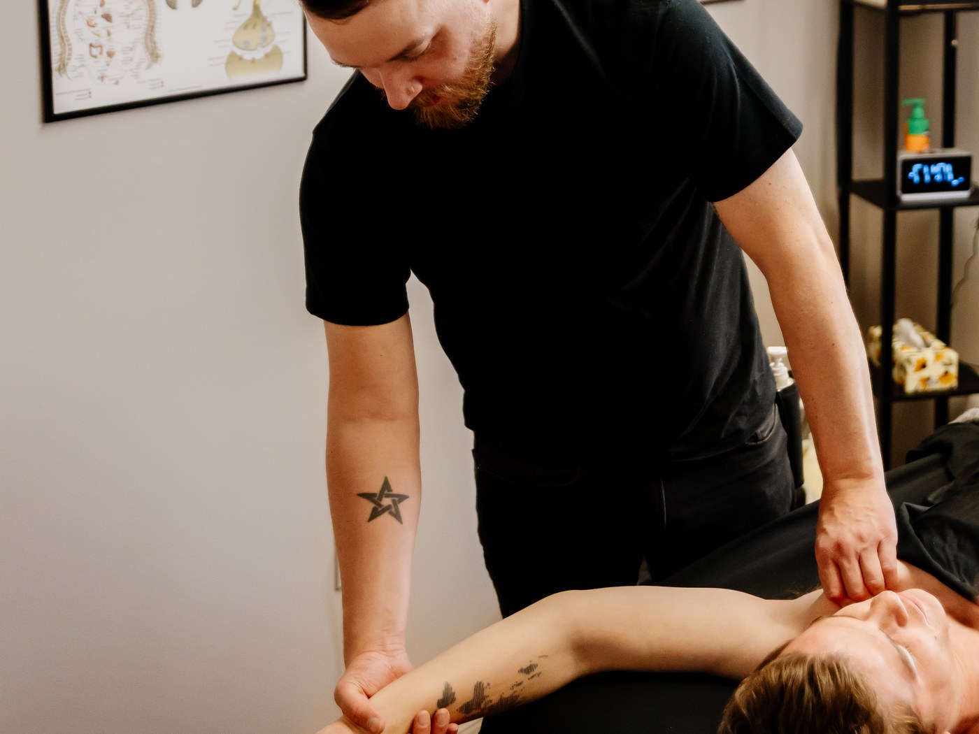 Mathieu guides a client's arm movement while applying focused shoulder pressure during RAPID.