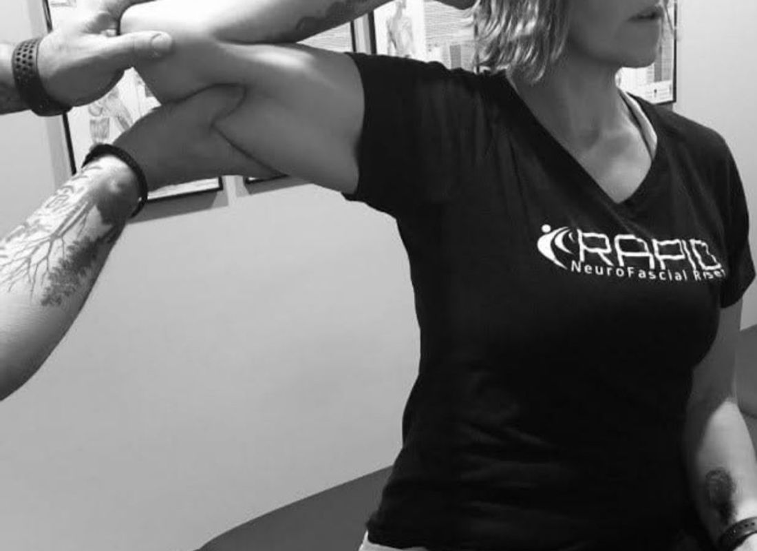 RAPID NeuroFascial Reset treatment in progress, hands-on shoulder mobilization.